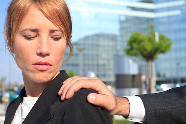 a male employee putting his hand on a female employee