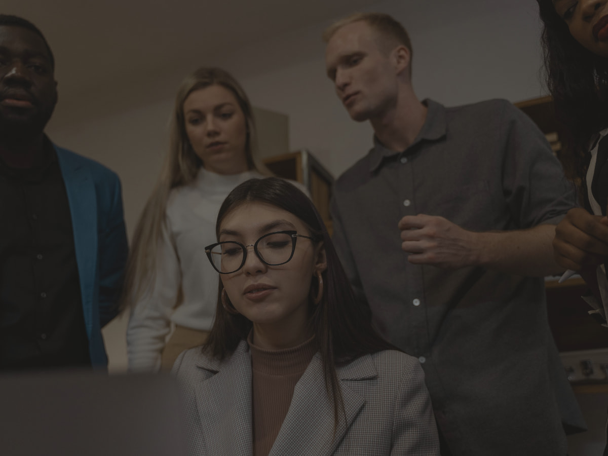 coworkers looking over another employee's working, potential disability discrimination lawsuit in Orange County