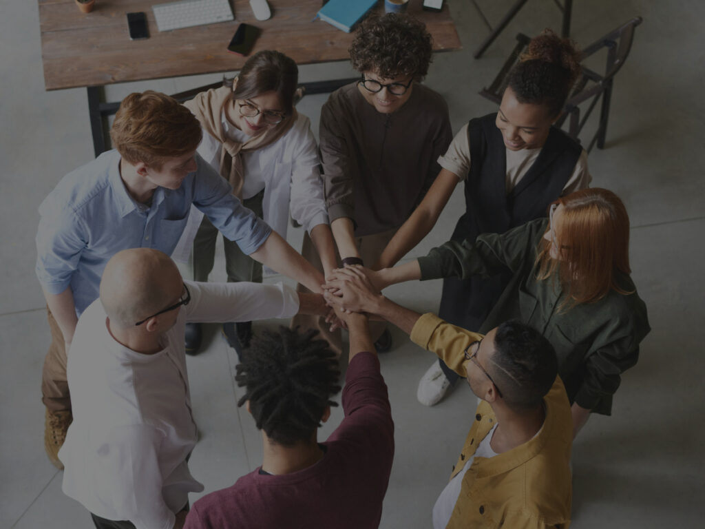 employees putting their hands in a circle